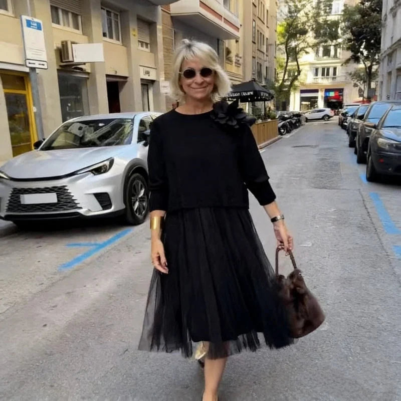 An elegant midi dress for women, featuring a multi-layered mesh design.