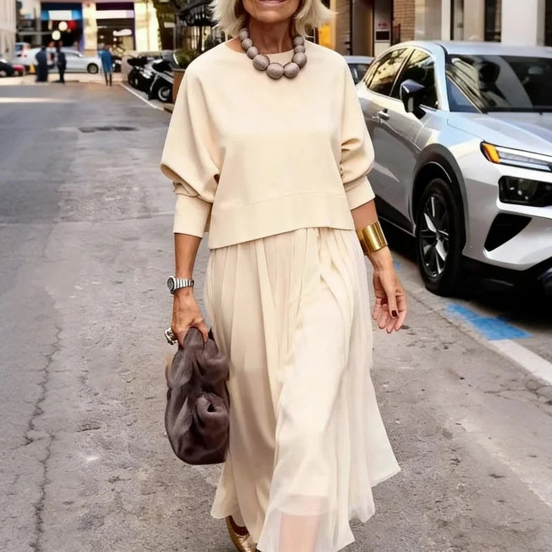 An elegant midi dress for women, featuring a multi-layered mesh design.