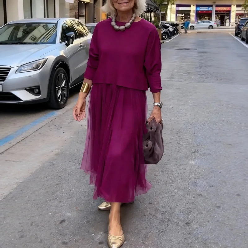 An elegant midi dress for women, featuring a multi-layered mesh design.